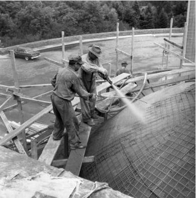Workmen spray down the McMath Planetarium dome, which is under construction. 1955. Cranbrook Archives. 