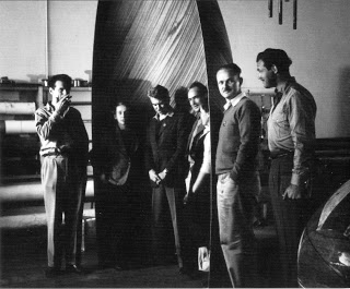 Eames Office staff with plywood glider nose section. Left to right: Charles Eames, Marion Overby, Gregory Ain, Harry Bertois, Ray Eames, William Francis and Norman Bruns. (Library of Congress Prints and Photographs Division. The Work of Charles and Ray Eames. Copyright, Eames Office).