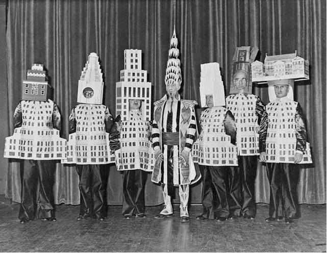 William Van Alen as the Chrysler Building, with other masquerading architects around him. On the far right is Joseph Freelander as the Museum of the City of New York.  Source: NY Times/untappedcities.com. 