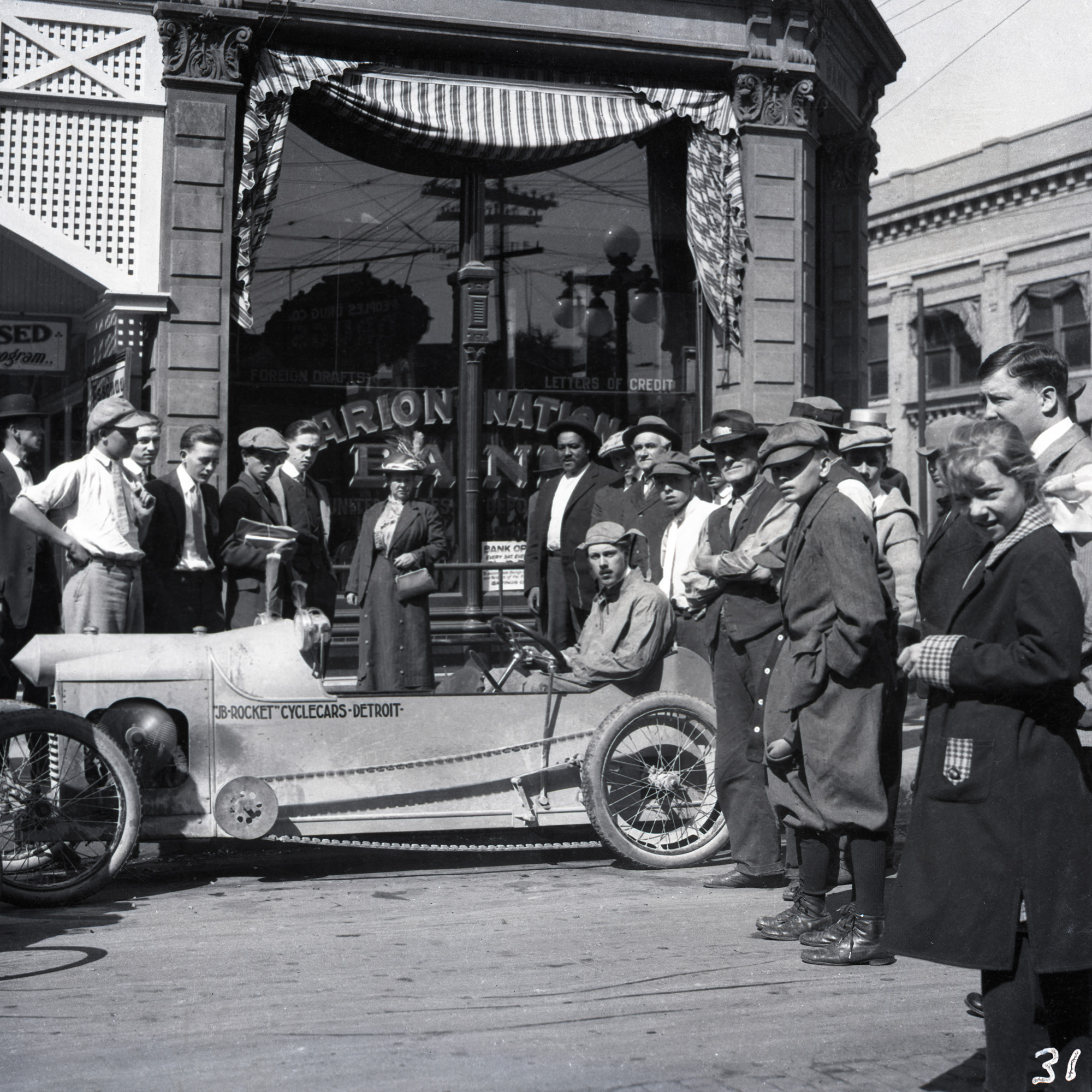 James Scripps Booth showing off the JB Rocket prototype in Indianapolis, the conclusion of a test-drive from Detroit to Indiana, 1913. Cranbrook Archives. 