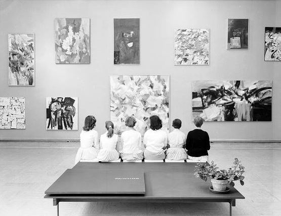 Young women take in the Annual Exhibition of Student Work at the Cranbrook Art Museum. The central painting is Untitled (1957) by student Frank Okada. June 1957. Harvey Croze/Cranbrook Archives. 