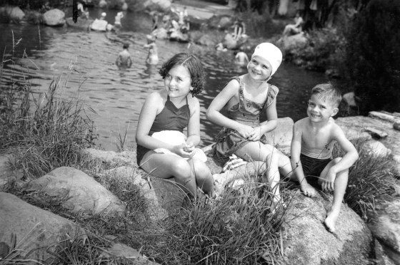 Children sitting on the rocks at Lake Jonah/Jonah Pools. Harvey Croze, photographer, Jul 1953.