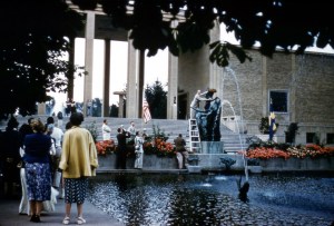 The Swedish Council Detroit places a wreath atop Milles' sculpture, Europa and the Bull. Henry Scripps Booth is holding the ladder and Cranbrook photographer, Harvey Croze, is in the foreground, to the left of the ladder. Courtesy Cranbrook Archives.