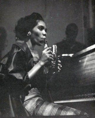 Pianist, Terry Pollard, plays the 7-Up bottle. Harvey Croze, photographer. Courtesy Cranbrook Archives.