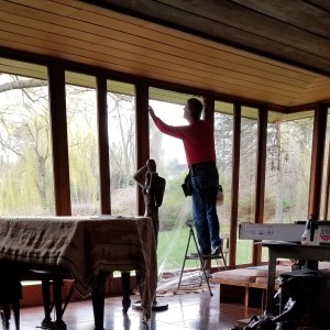 Bill Kish of SRF Enterprises, Inc. installing window film in Smith House.
