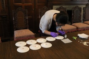 Desai, applying removable adhesive on Booths’ saucers to attach inventory numbers. 