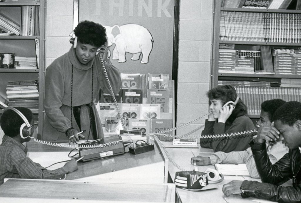 grayscale photo of teacher with students
