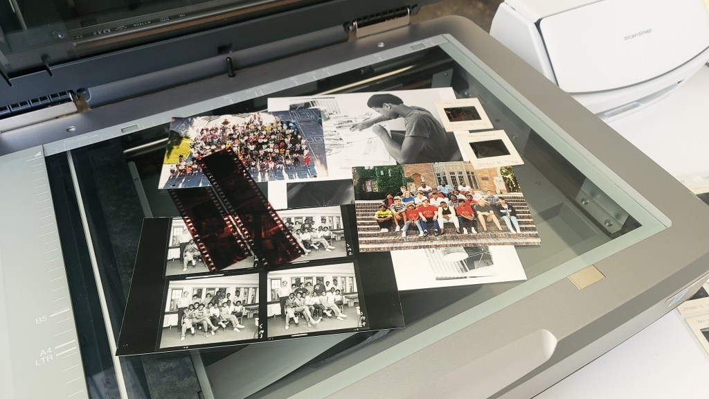 scanner with various photographs laying on top